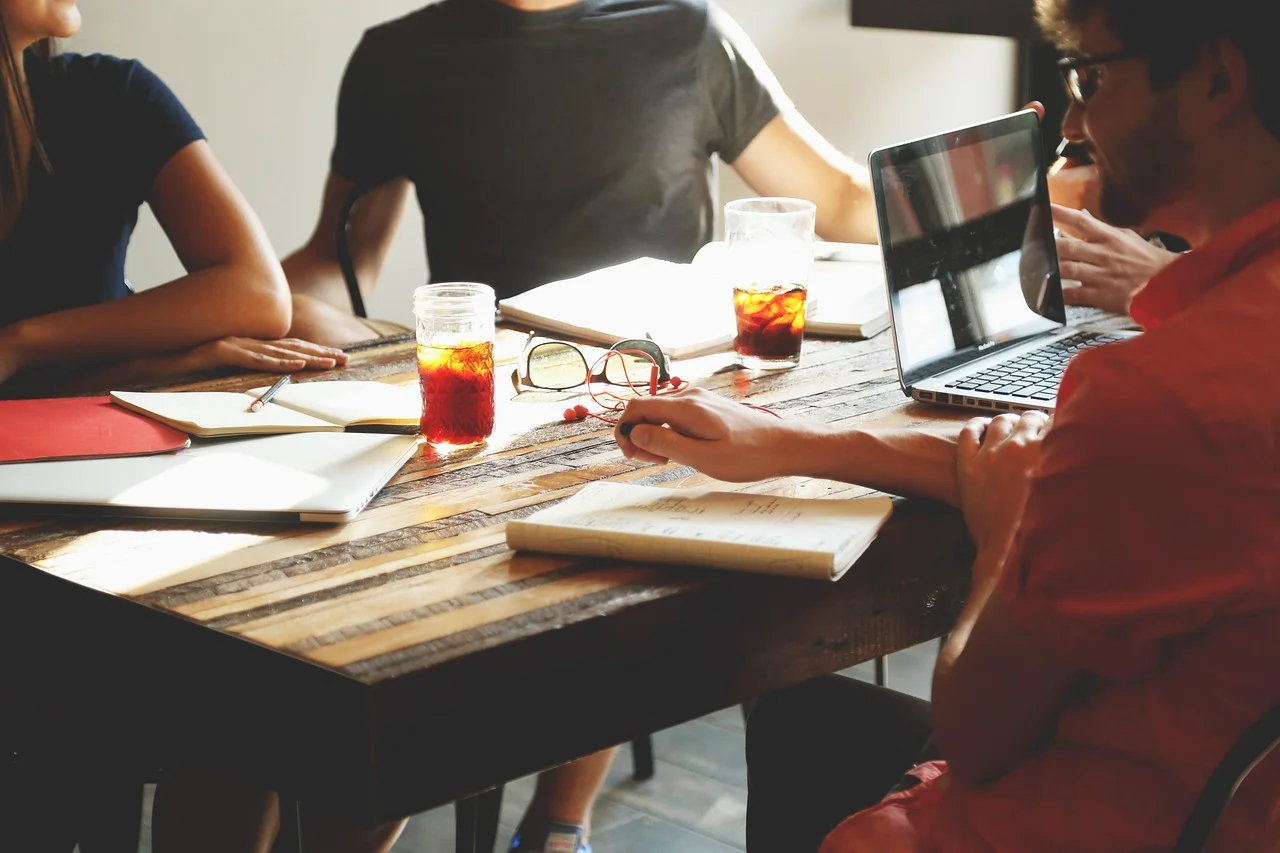 Small business team gathered around a laptop in a conference room