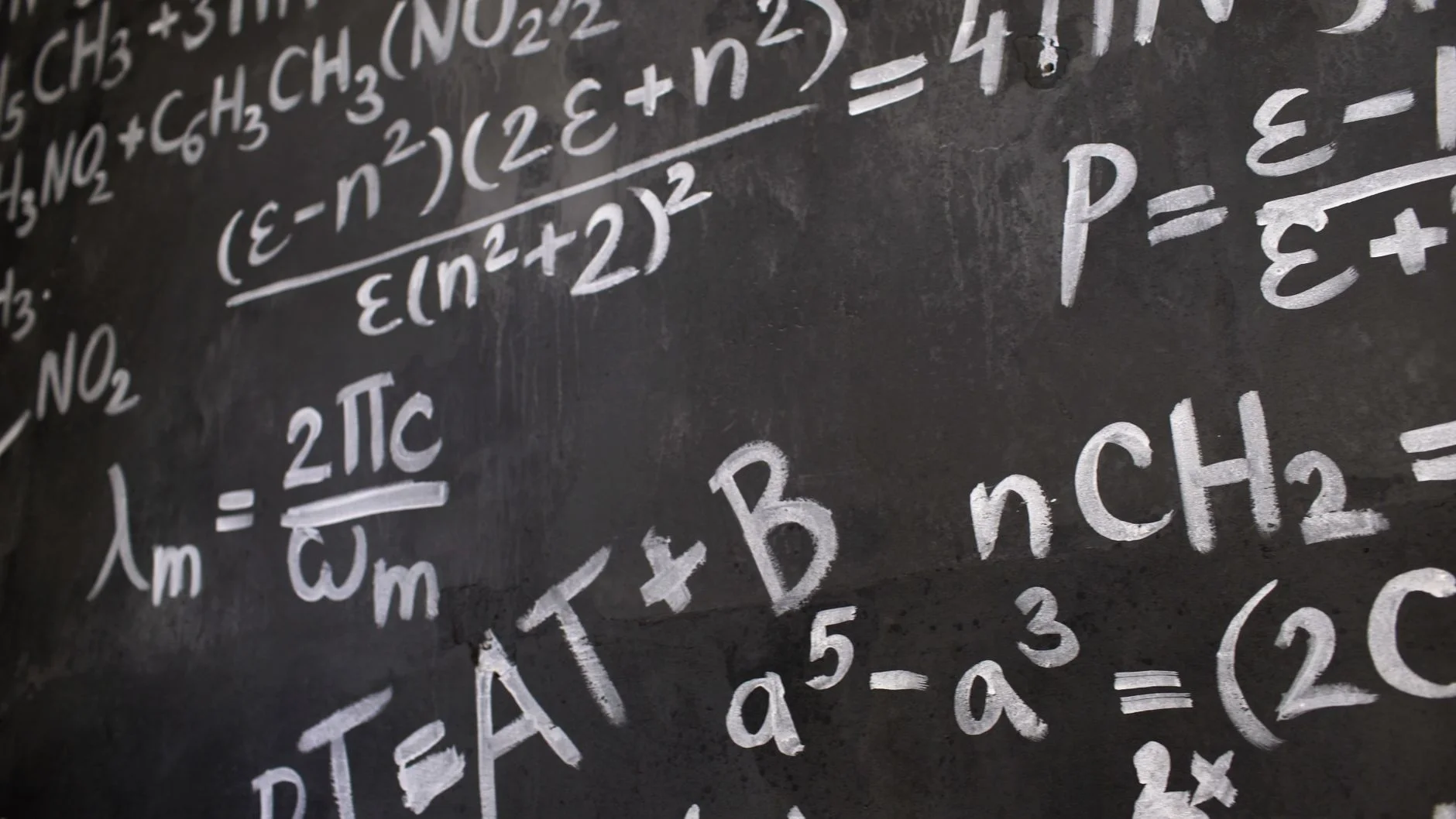 A chalkboard covered in handwritten formulas representing careful logical review