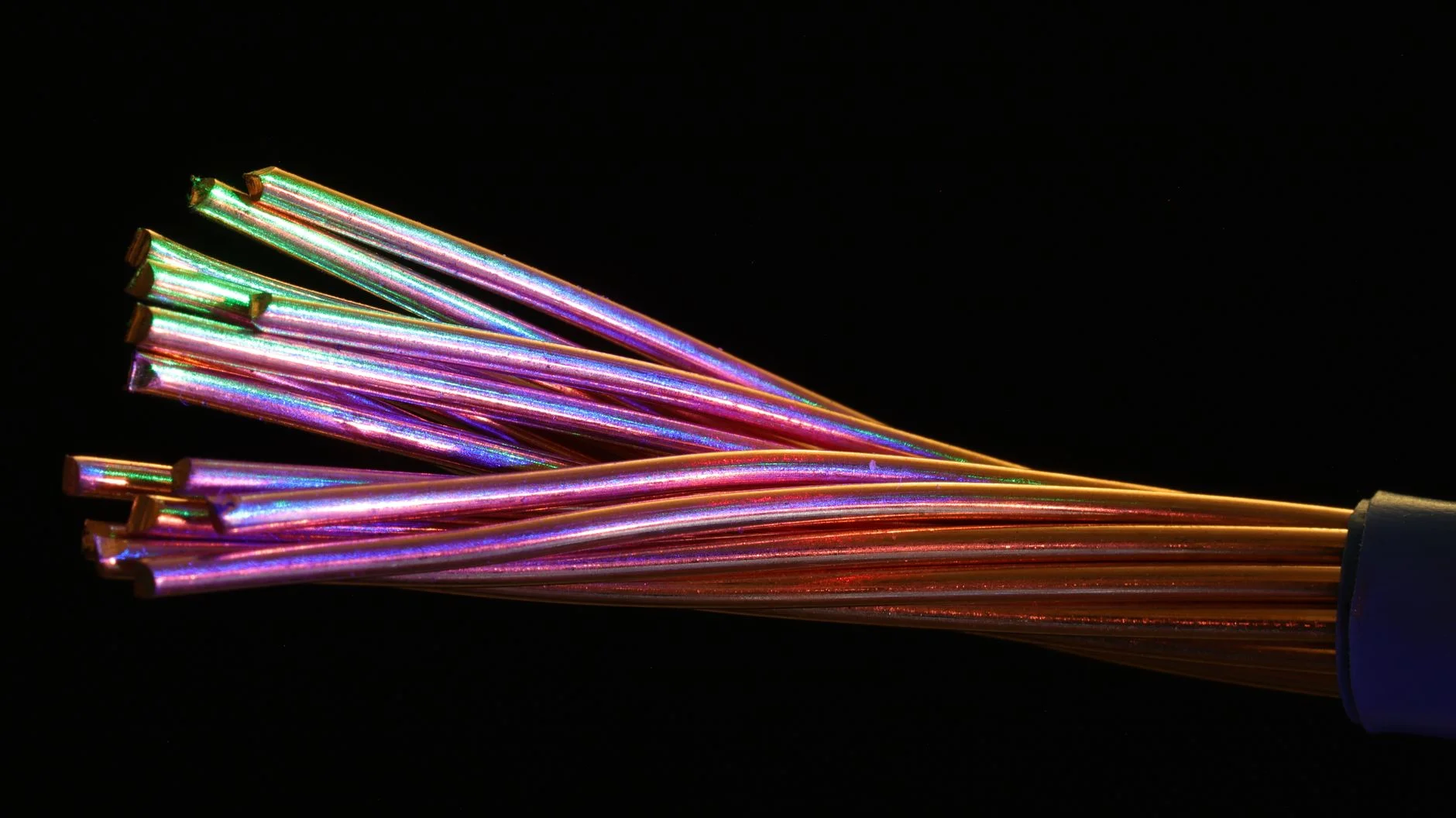 Glowing fiber optic cable strands representing two-way data synchronization between systems