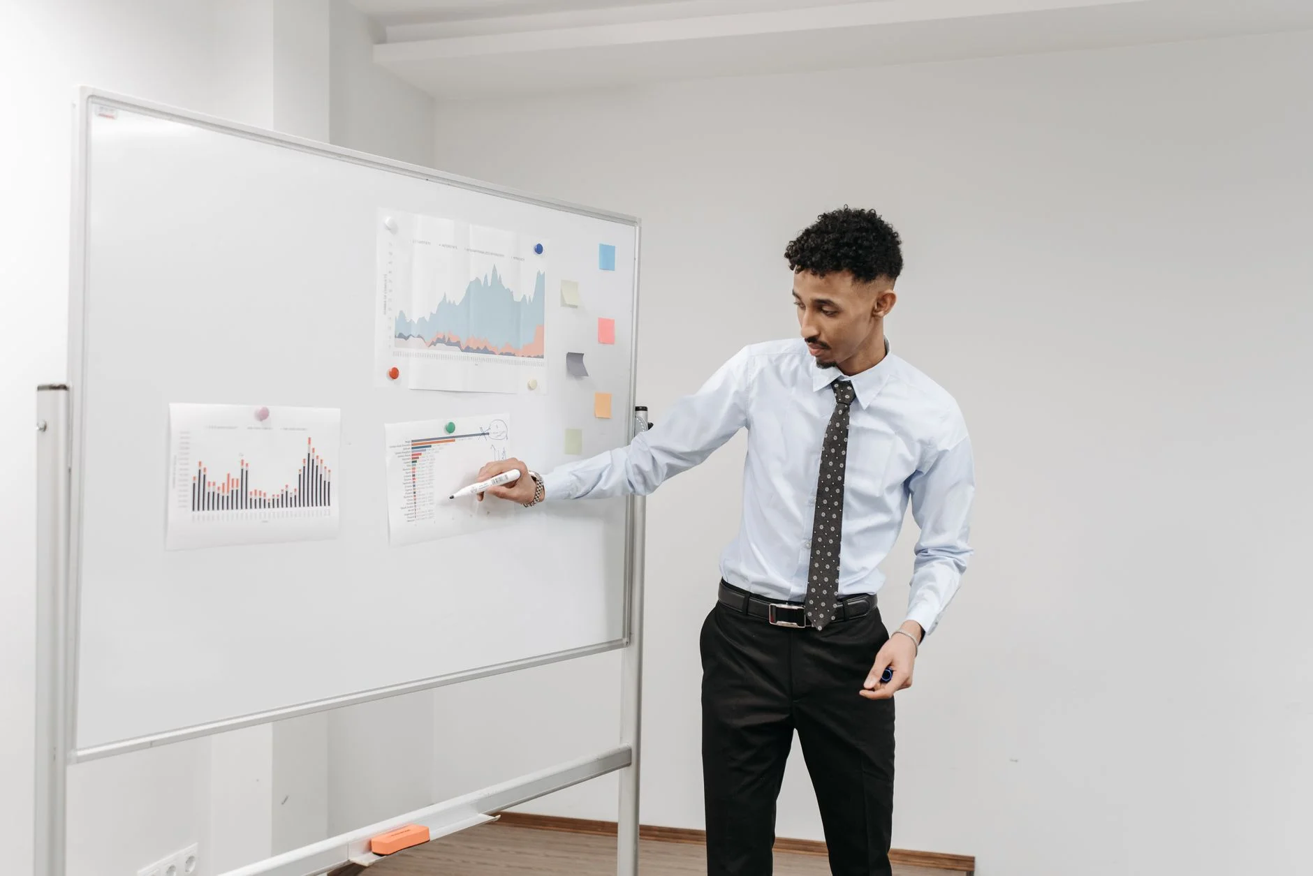 A boardroom whiteboard covered in charts and strategy notes during a planning session