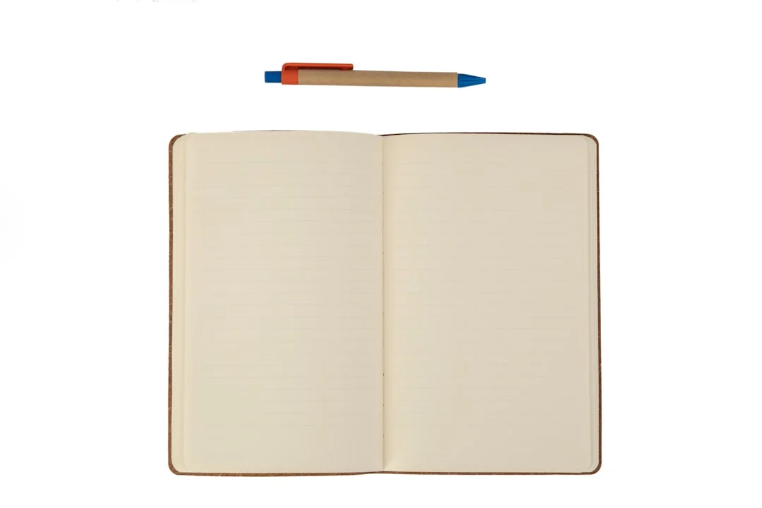Notebook page with annotated diagrams and a pen, representing structured evaluation notes for a coding tool comparison