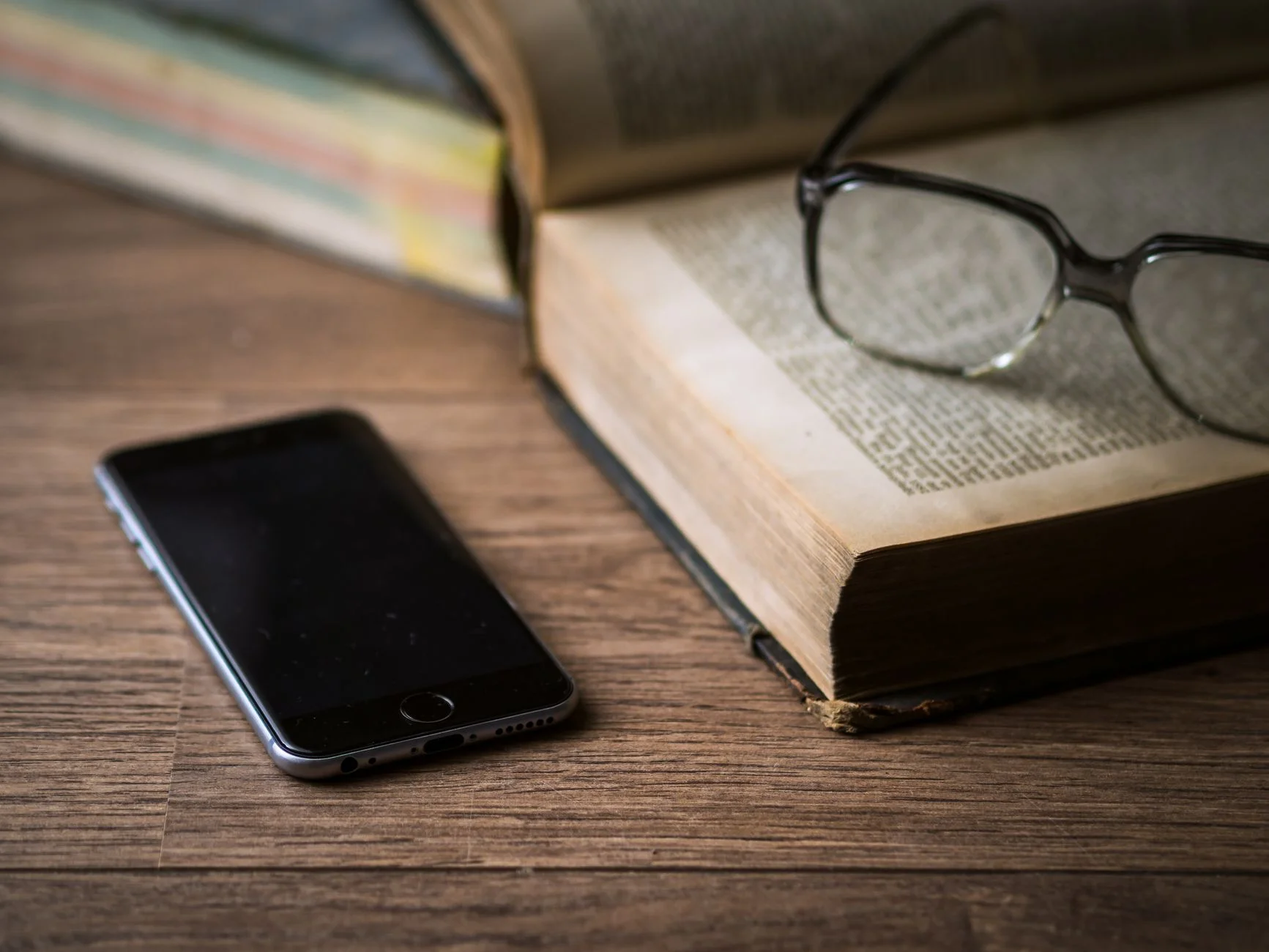 Reading glasses resting on a printed report on a desk