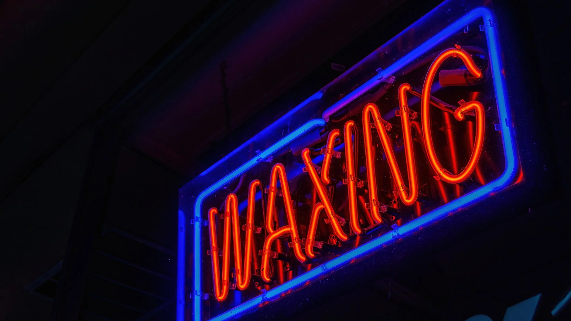 Neon sign glowing brightly against a dark night background