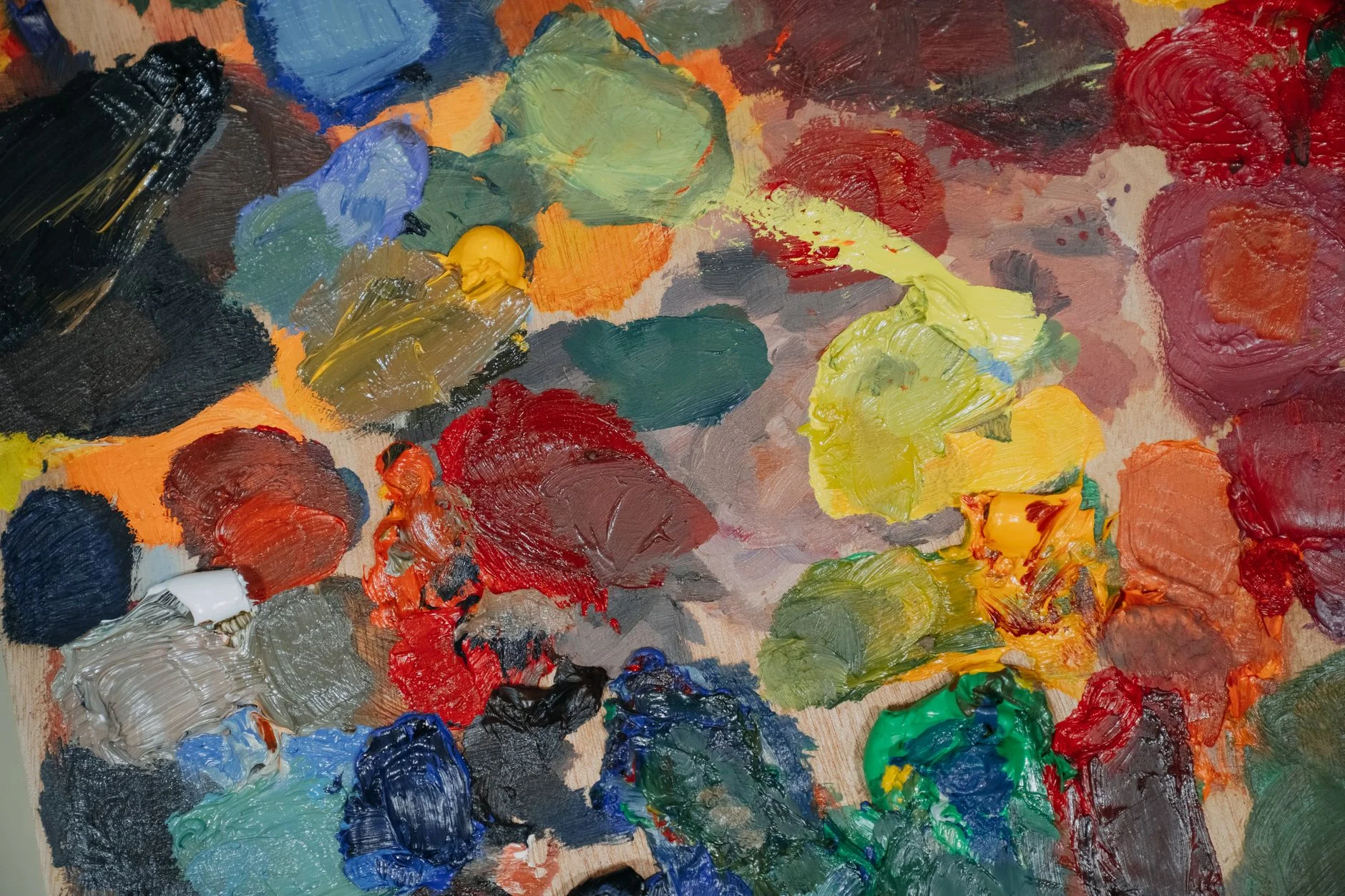 A fan of paint color swatches arranged in graduated sizes on a studio table