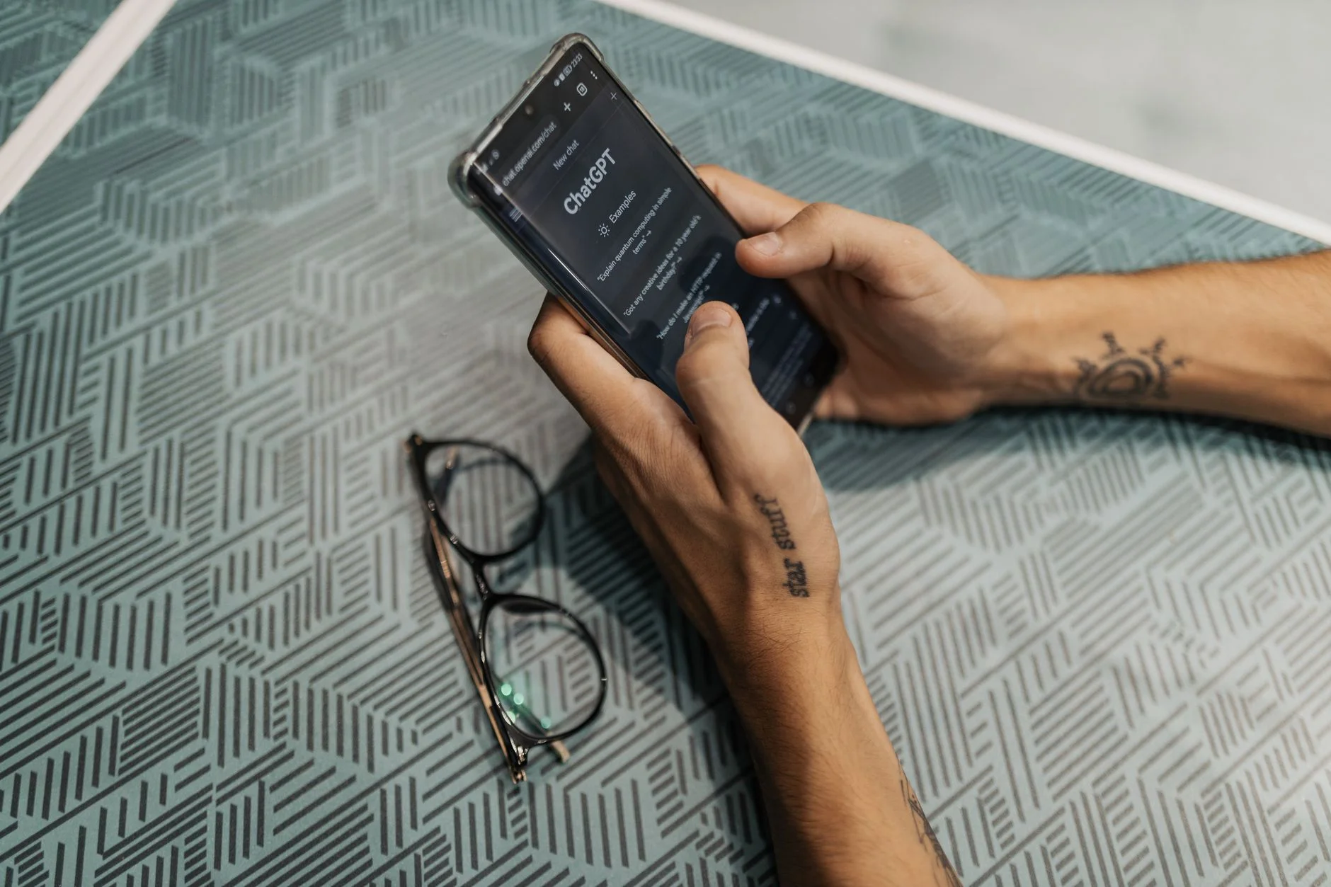Hand holding a smartphone showing a signup screen up close